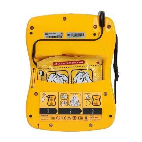Rückseite des Defibtech Lifeline VIEW AED Medasi.shop mit integriertem Fach für Elektrodenpads und bebilderter Anleitung. Perfekt für schnelle Anwendung.